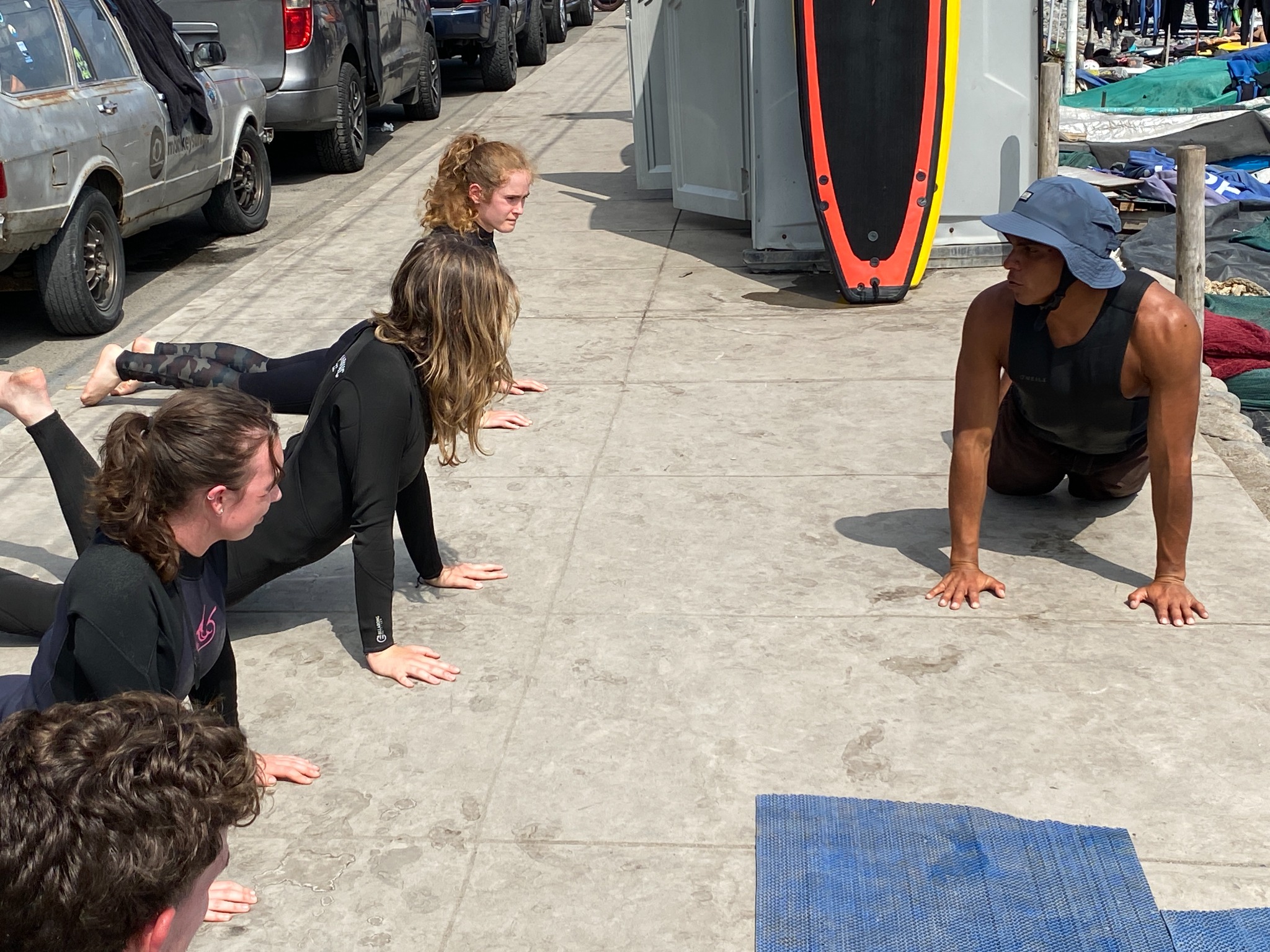 Instructor guiding students through a movement before entering the water