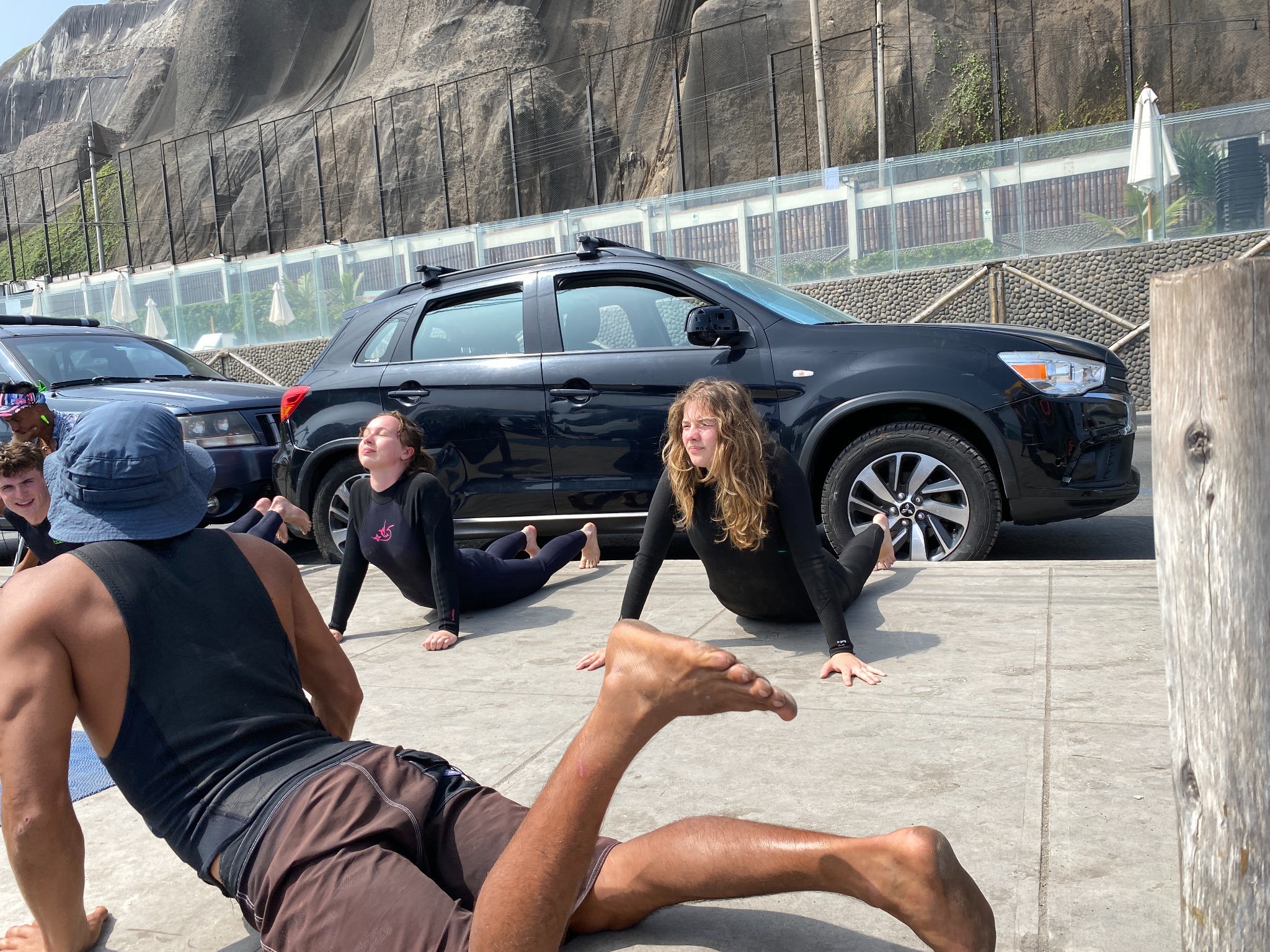 Instructor and students practicing a surf warm-up on the promenade