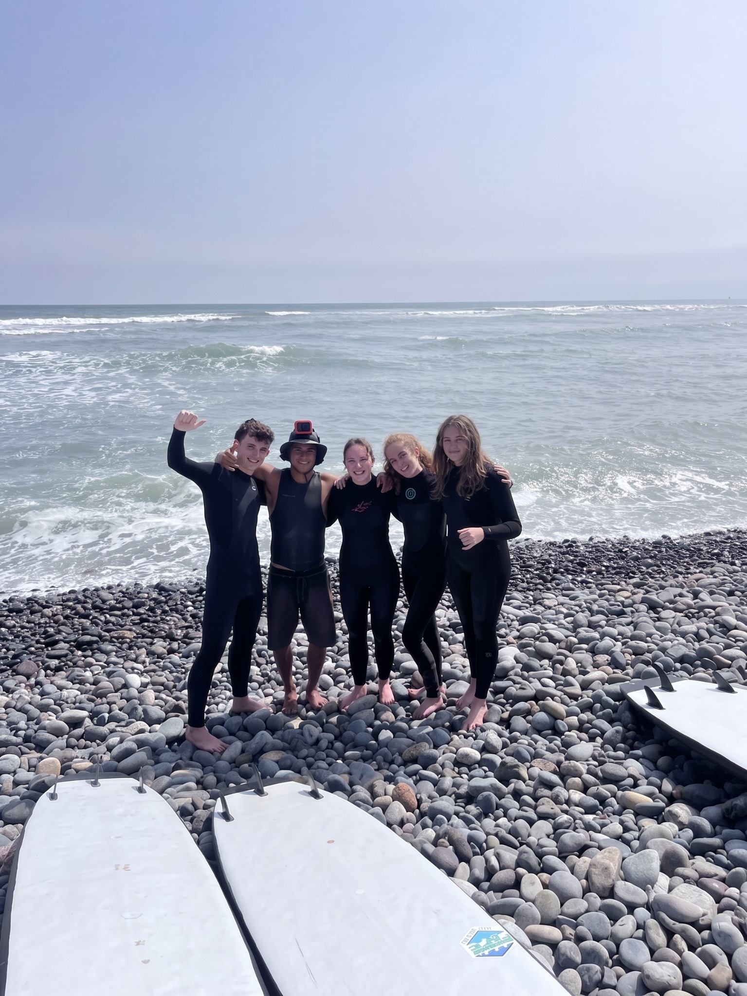 Monkey Surf instructor and students together on the beach after a surf lesson